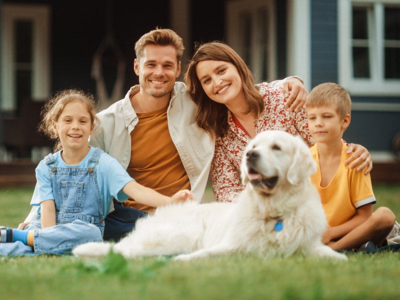 Couple in front of their new conventional-mortgage home