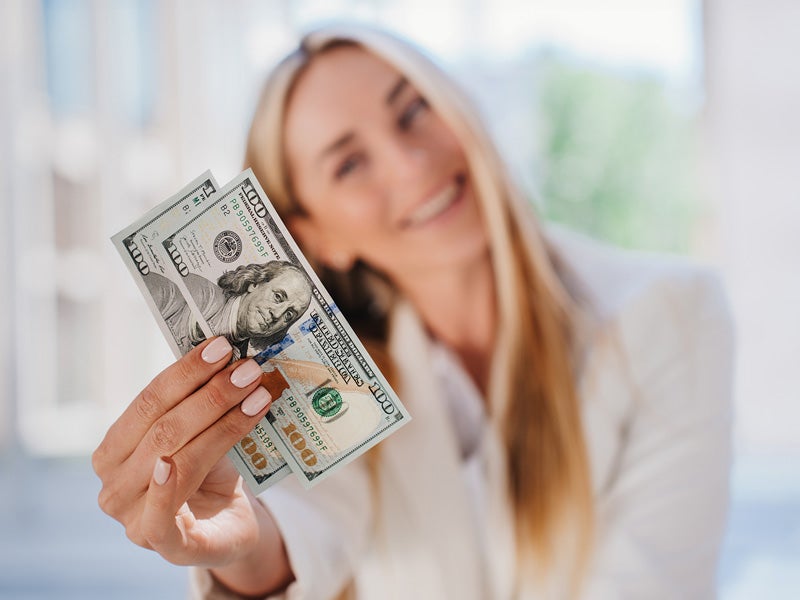 AFCU member depositing cash into regular savings account at branch